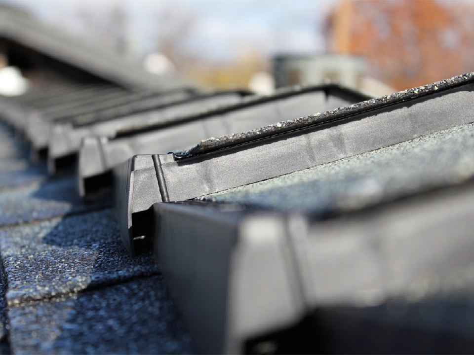 Close detail of ridge cap and metal flashing on a finished roof