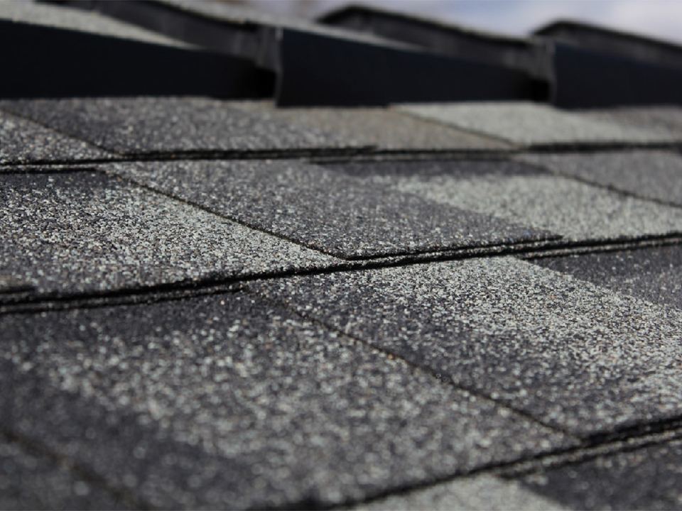 Close detail of layered architectural shingle tabs on a finished roof