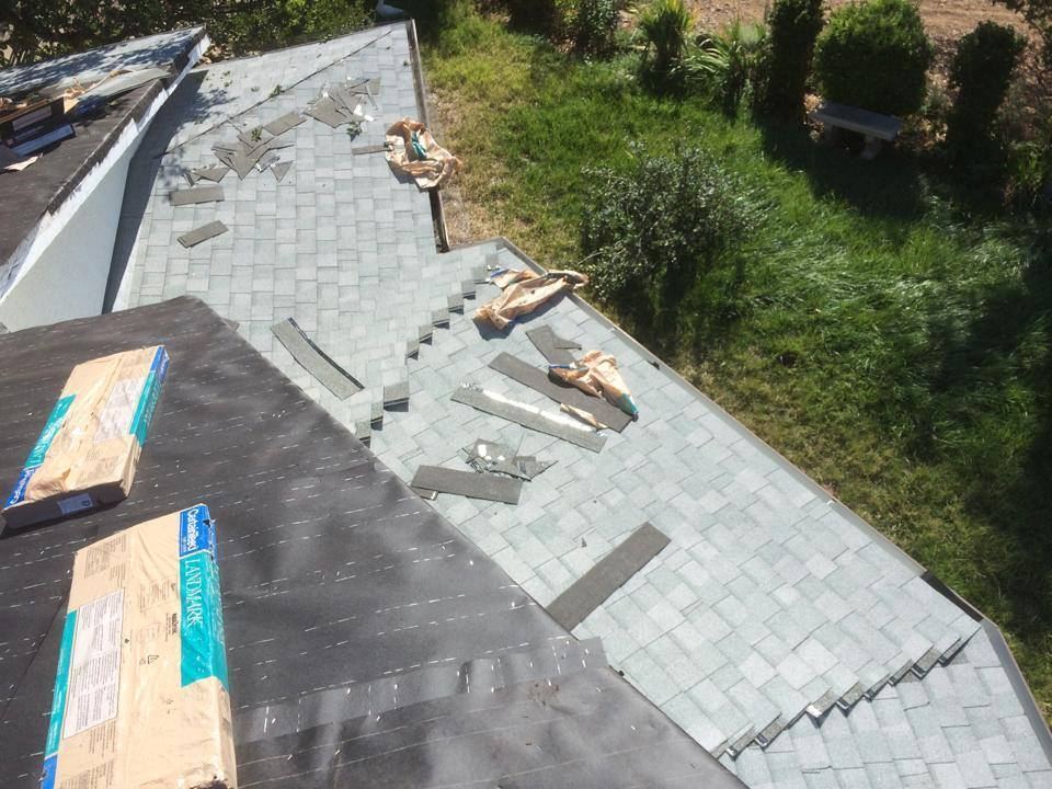 Shingle bundles staged along a roof ridge during installation