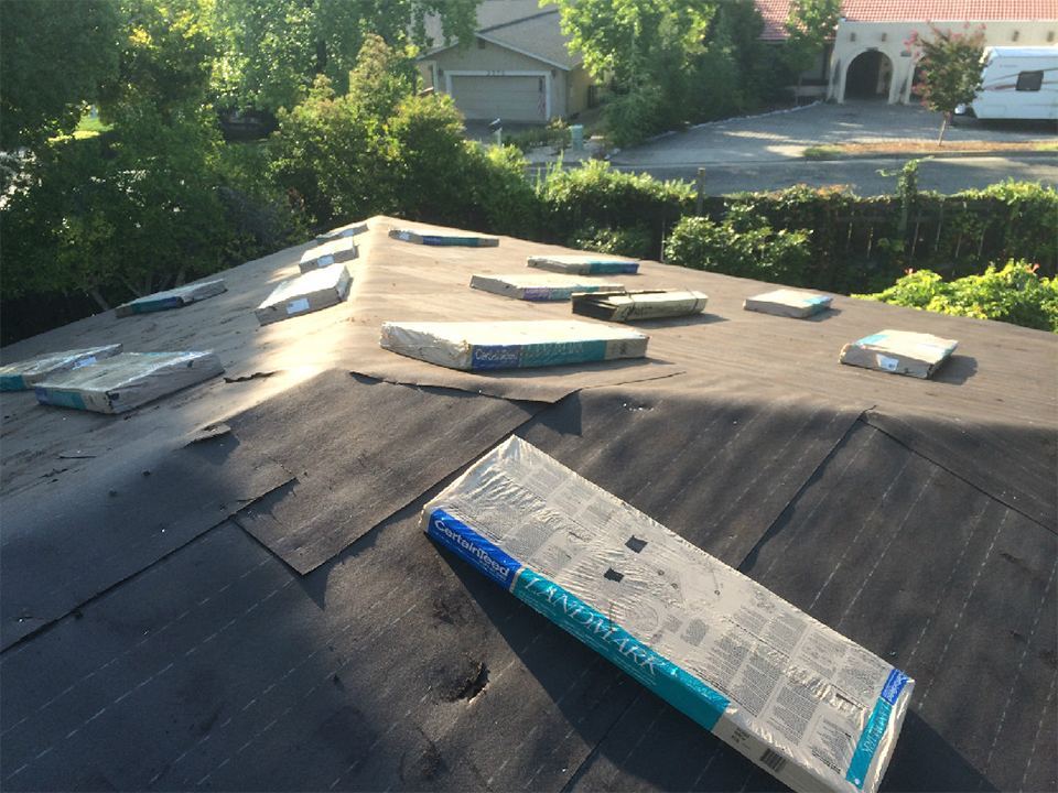 Low-slope roof section prepared with vents before membrane installation