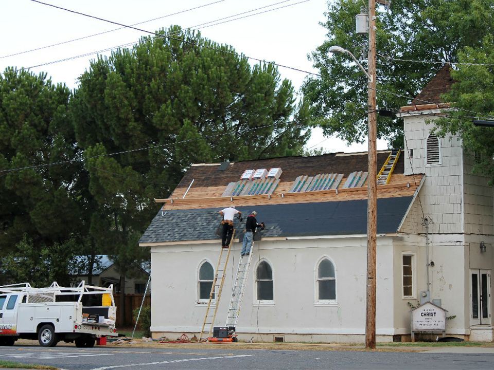 Crew working on the reroof of a historic white church in Northern California
